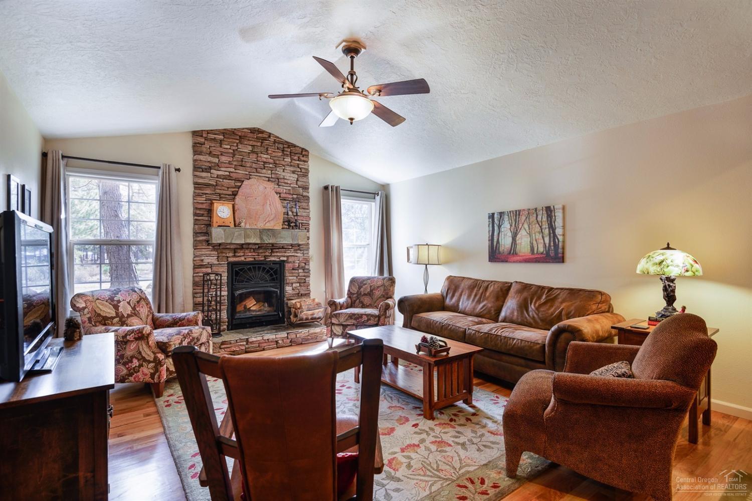 60030 Navajo Road Bend, OR 97702 - Photo 5 of 20 a living room with furniture a fireplace and a flat screen tv