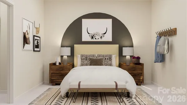 a bed sitting in a bedroom and table