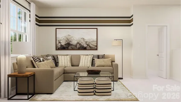 a living room with furniture a couch and paintings on the wall