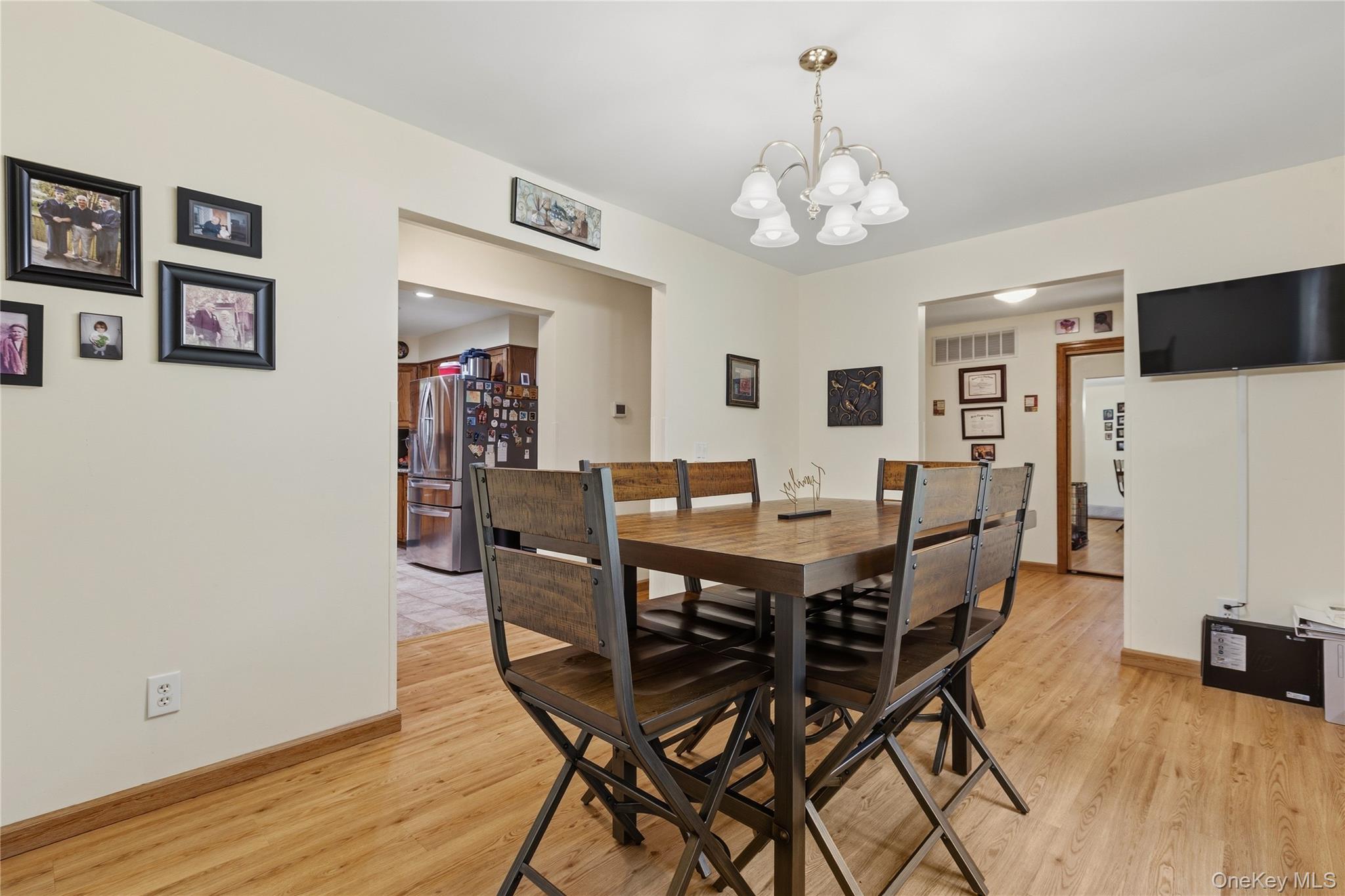 239-241 Fosler Road Highland, NY 12528 - Photo 11 of 42 Dining area featuring wood-finish flooring and a central chandelier