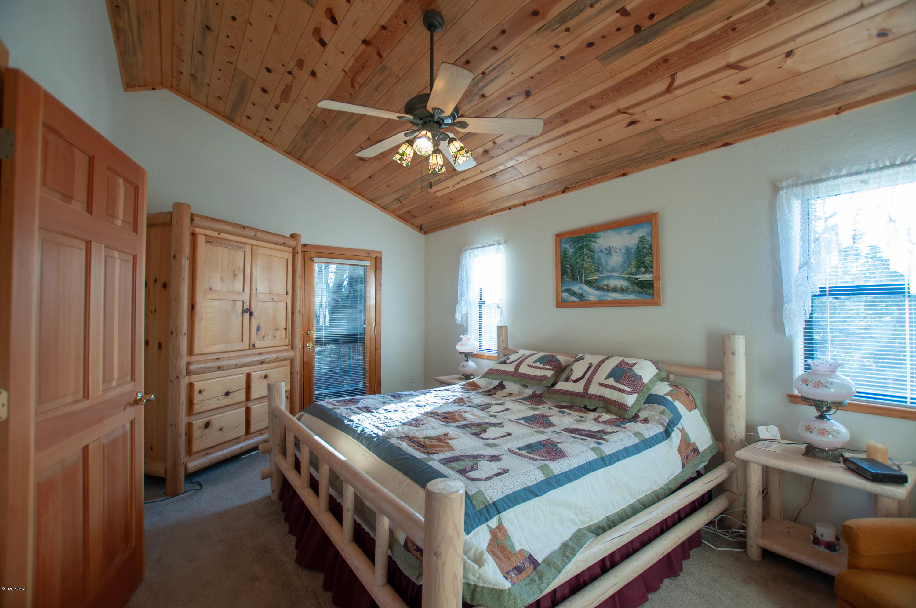 2836 Lodgepole Road Overgaard, AZ 85933 - Photo 14 of 25 a bedroom with a bed and a chandelier