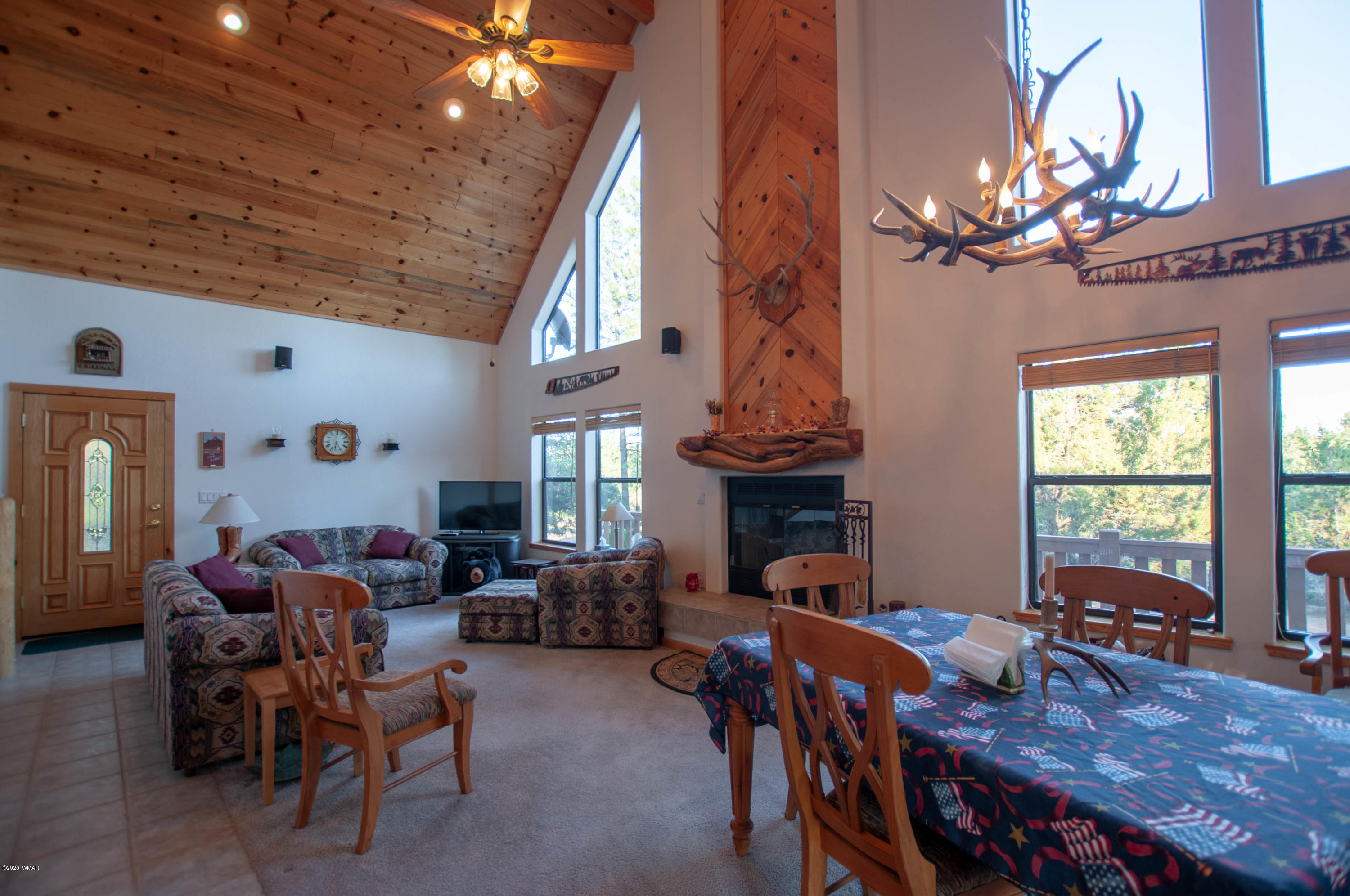 2836 Lodgepole Road Overgaard, AZ 85933 - Photo 3 of 25 a living room with fireplace furniture and a chandelier