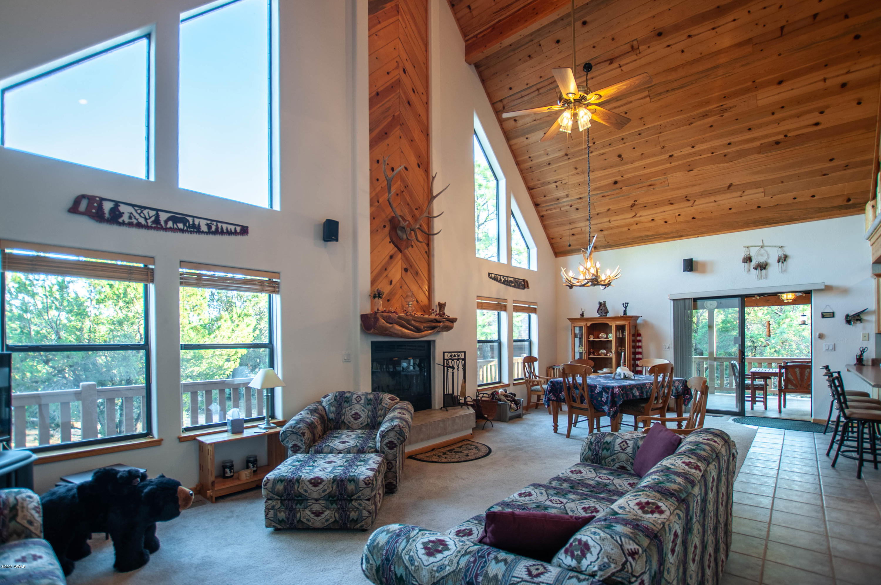 2836 Lodgepole Road Overgaard, AZ 85933 - Photo 5 of 25 a living room with furniture fireplace and a large window