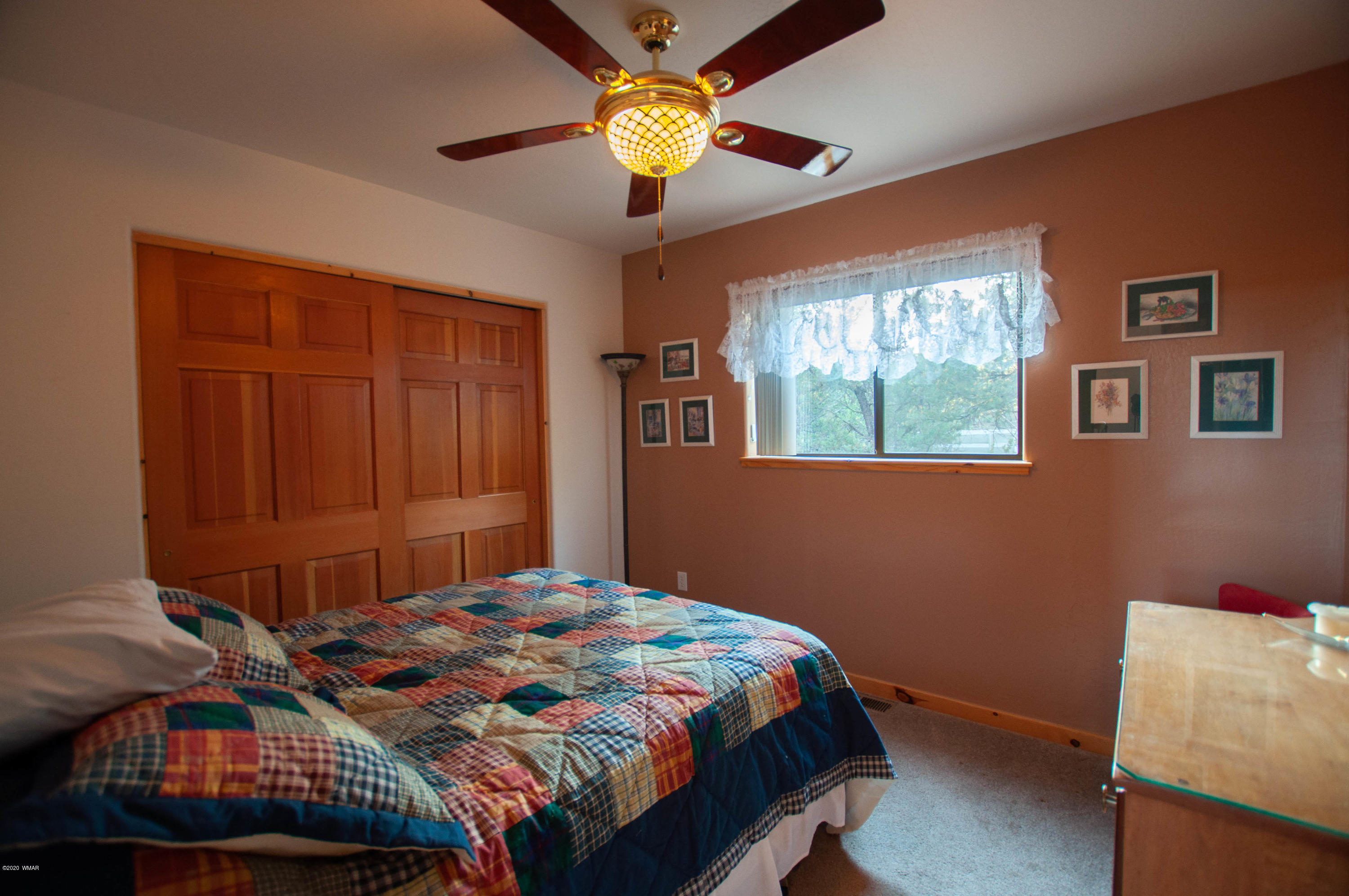 2836 Lodgepole Road Overgaard, AZ 85933 - Photo 8 of 25 a bedroom with a bed and a chandelier