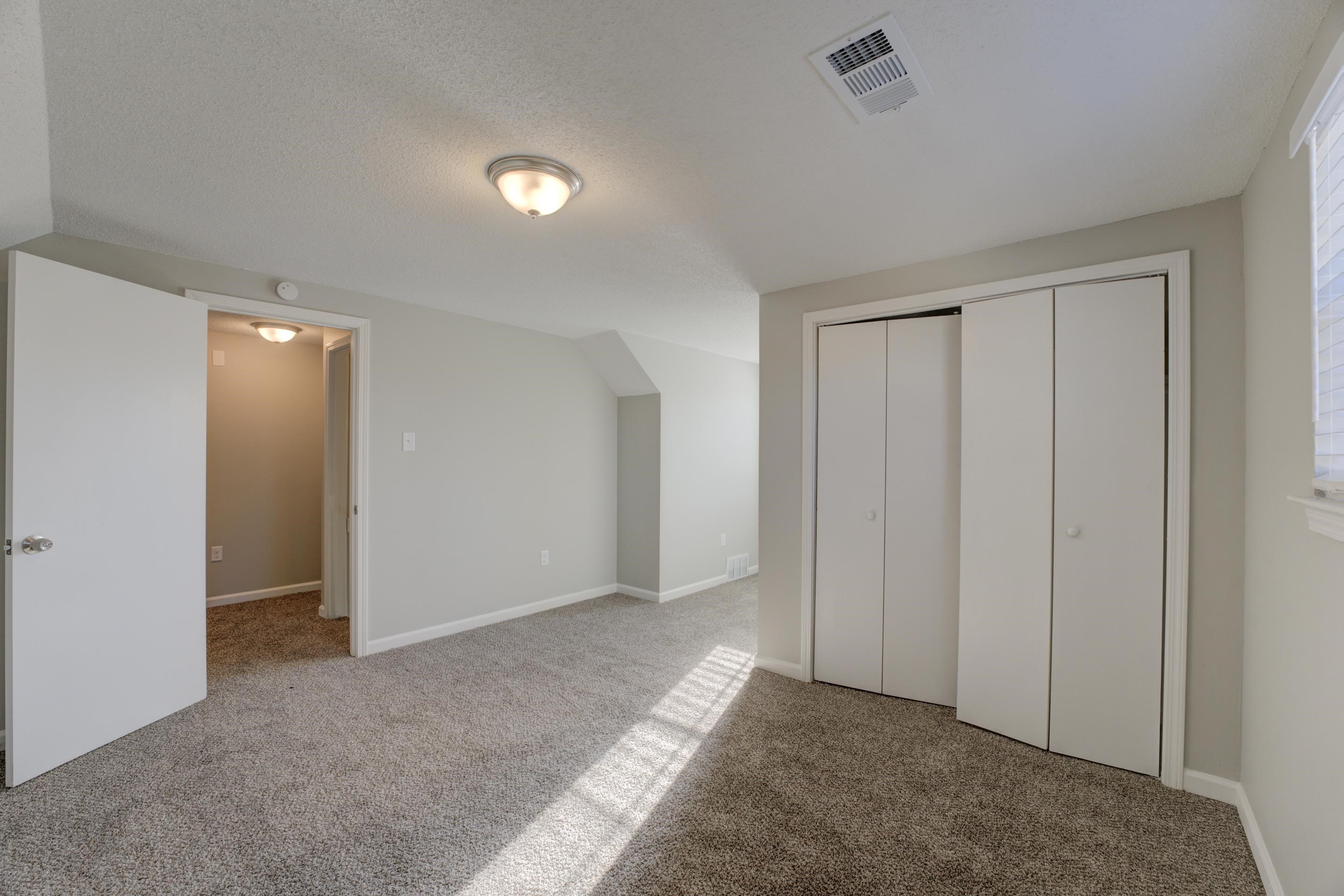 3808 Haynes Road Bartlett, TN 38133 - Photo 12 of 24 Unfurnished bedroom with light carpet, a closet, and a textured ceiling