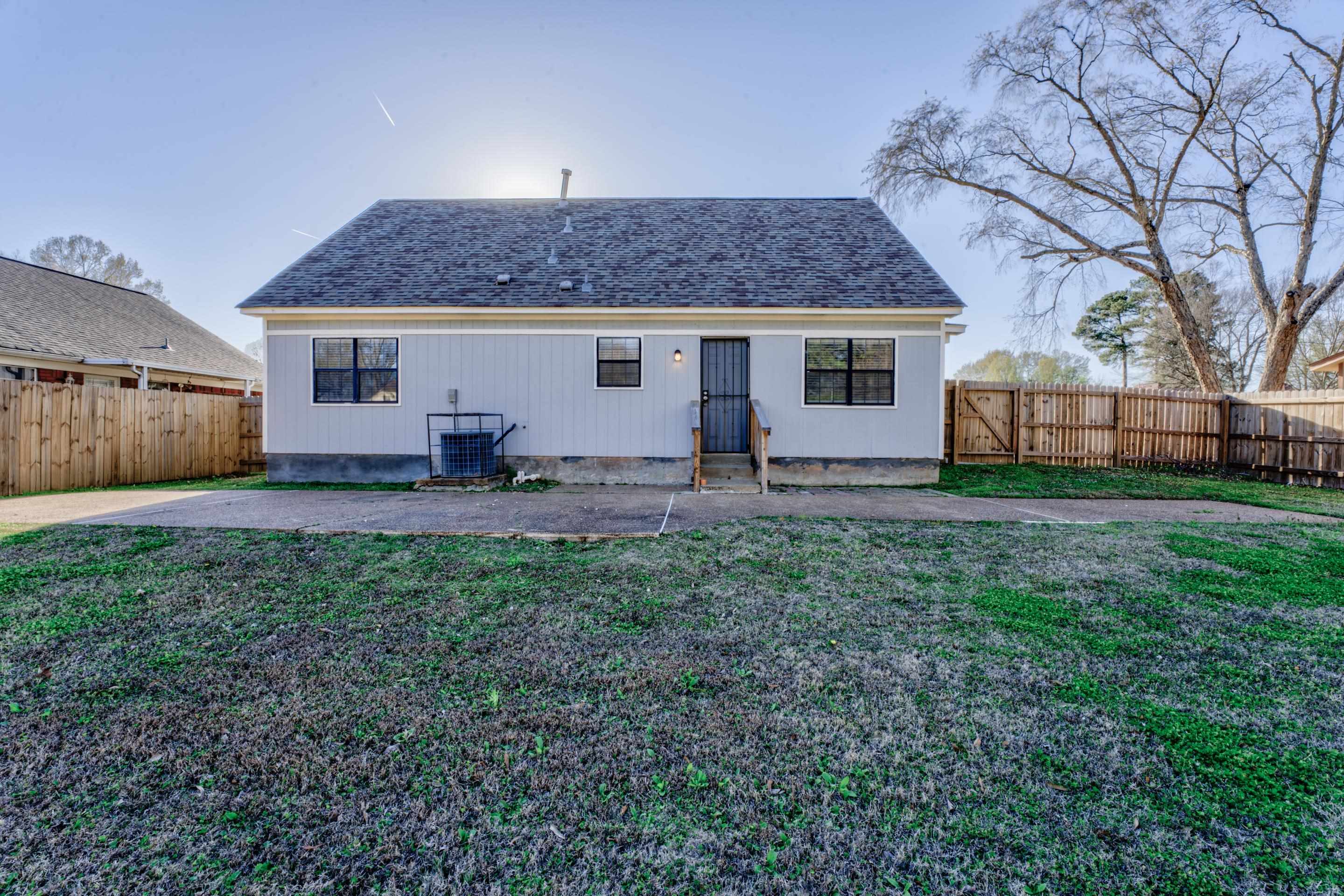 3808 Haynes Road Bartlett, TN 38133 - Photo 2 of 24 Rear view of property with a patio area, a yard, and cooling unit