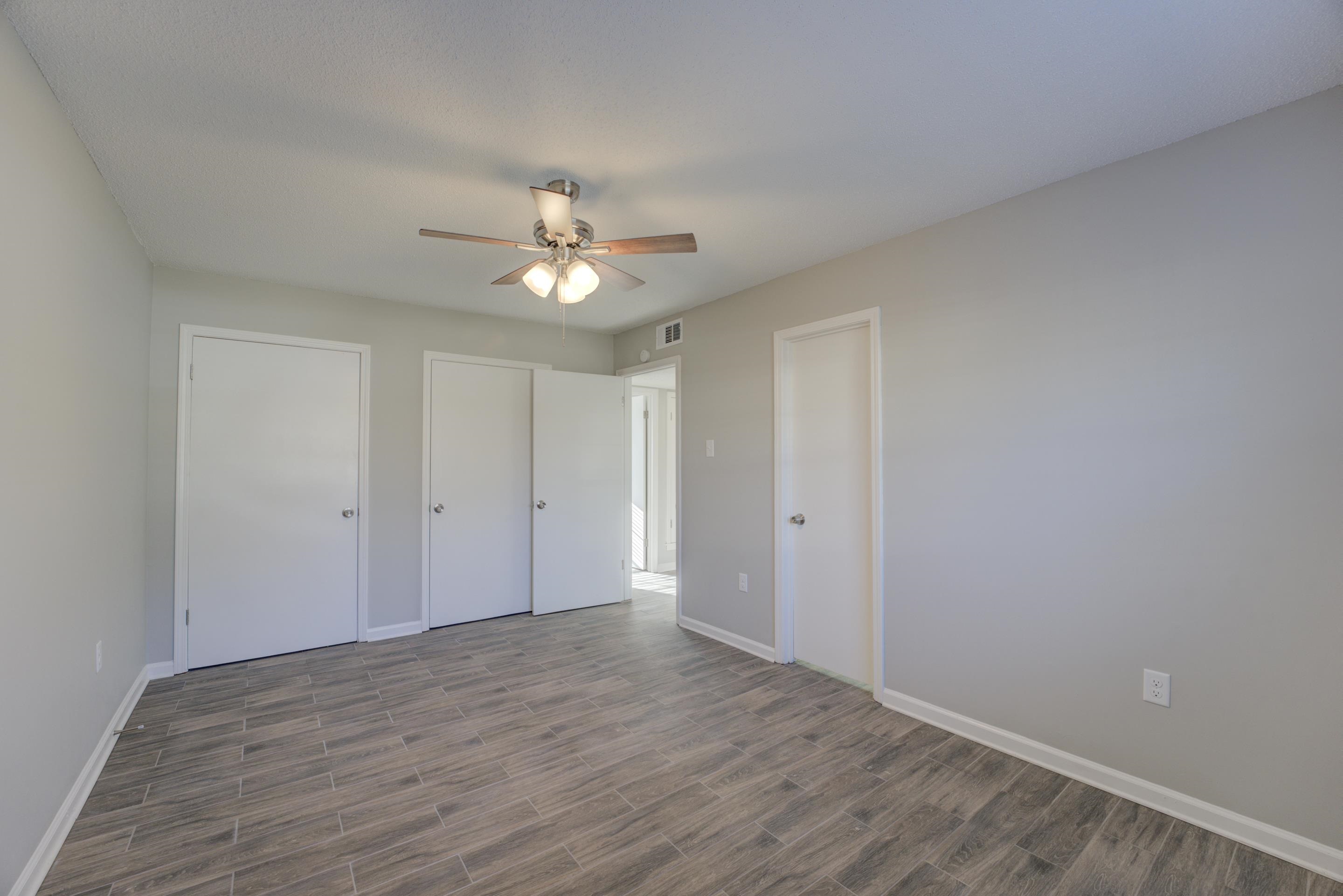 3808 Haynes Road Bartlett, TN 38133 - Photo 21 of 24 Unfurnished bedroom with hardwood / wood-style floors, two closets, and ceiling fan