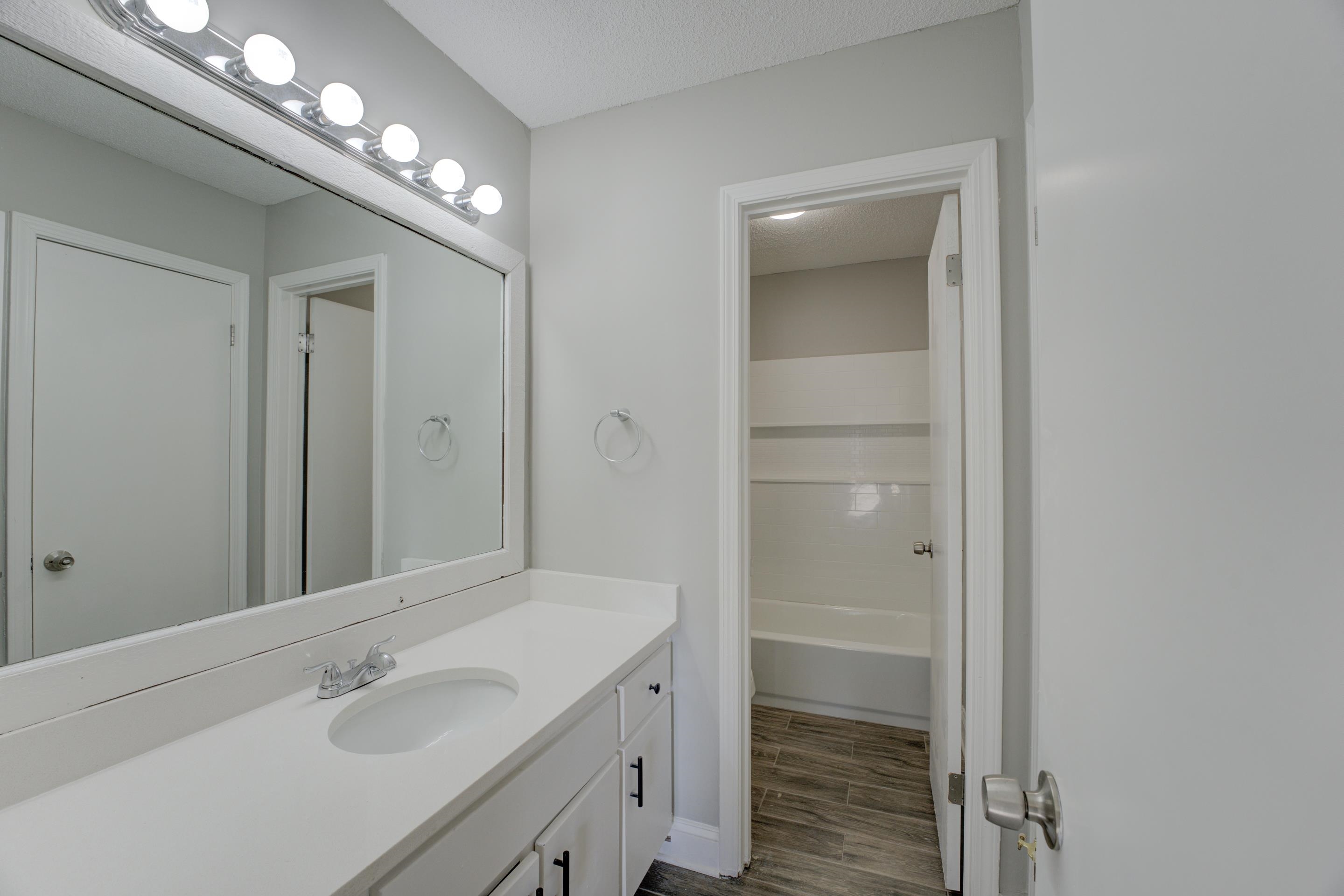 3808 Haynes Road Bartlett, TN 38133 - Photo 24 of 24 Bathroom featuring a textured ceiling, wood-type flooring, and vanity