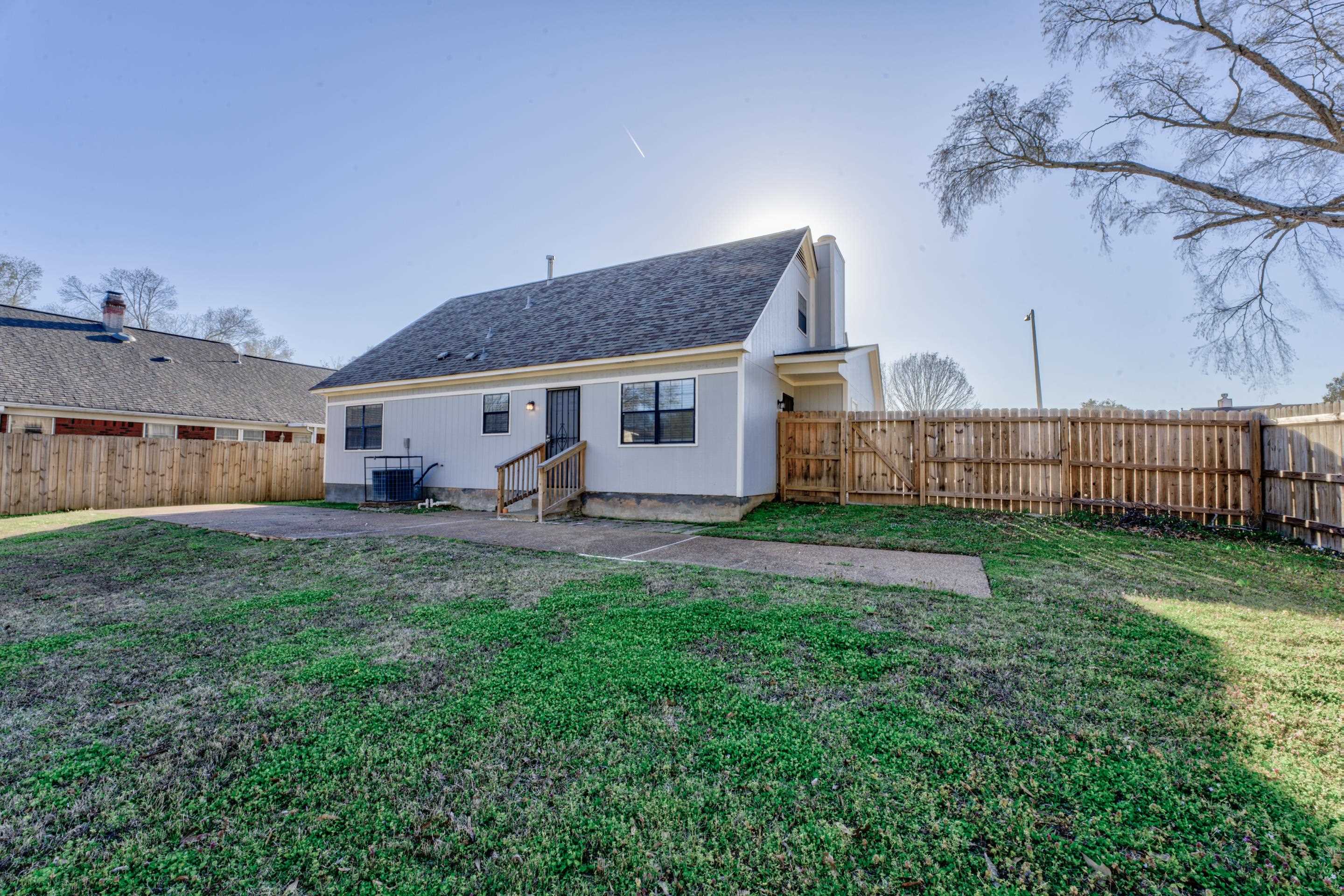 3808 Haynes Road Bartlett, TN 38133 - Photo 5 of 24 Rear view of property with central AC unit, a yard, and a patio area