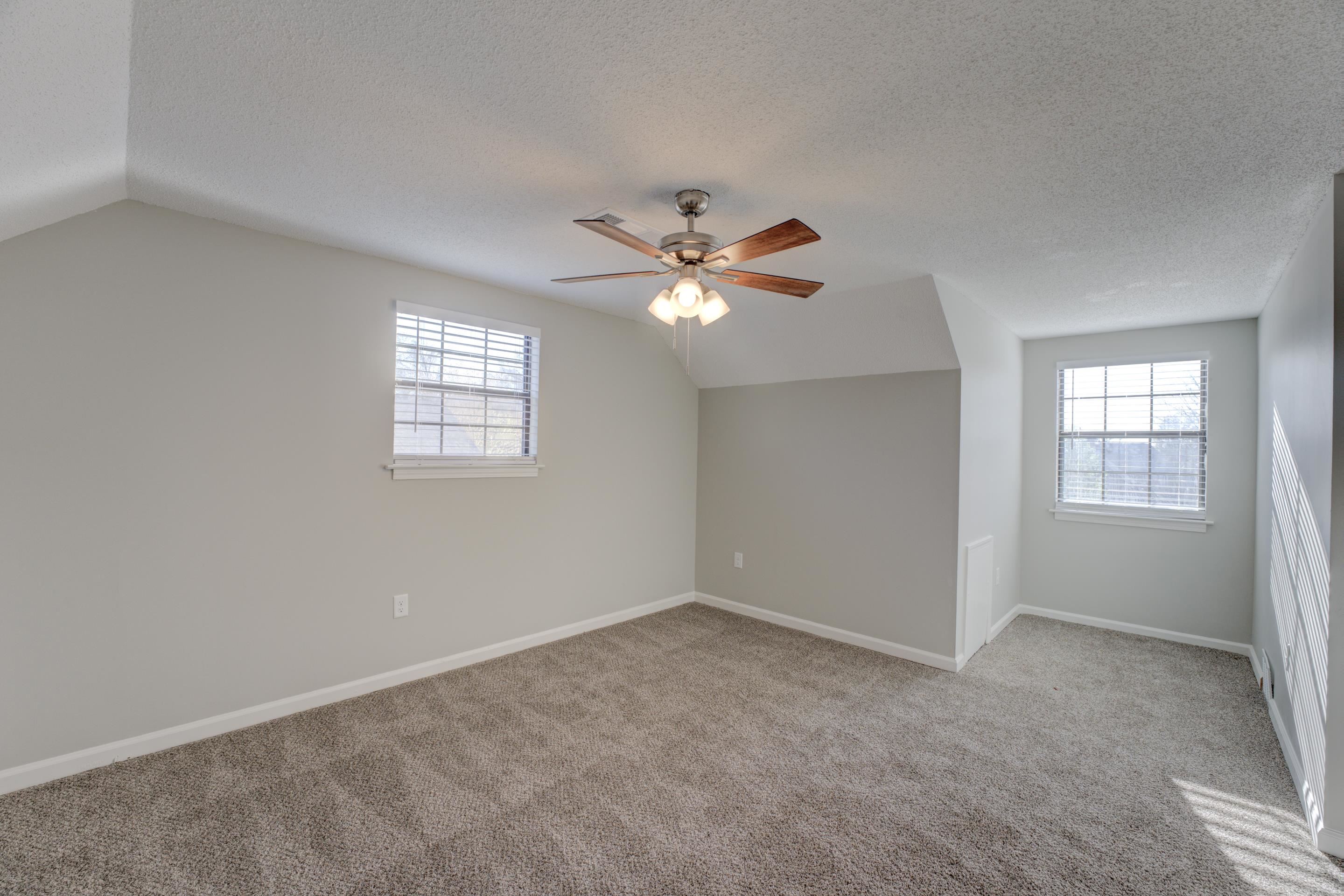 3808 Haynes Road Bartlett, TN 38133 - Photo 7 of 24 Empty room with ceiling fan, vaulted ceiling, a textured ceiling, and light colored carpet