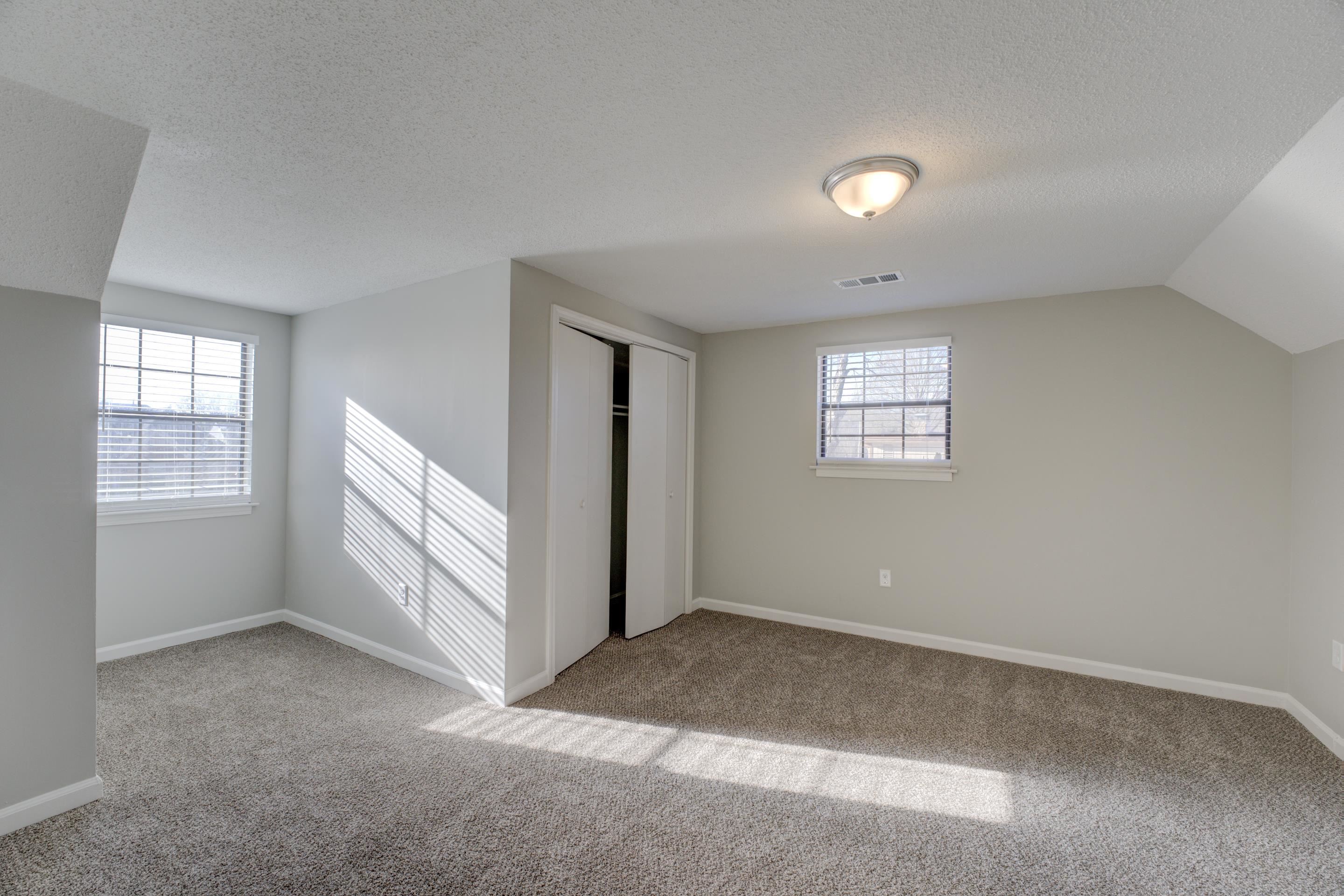 3808 Haynes Road Bartlett, TN 38133 - Photo 8 of 24 Unfurnished bedroom with carpet, multiple windows, and a textured ceiling