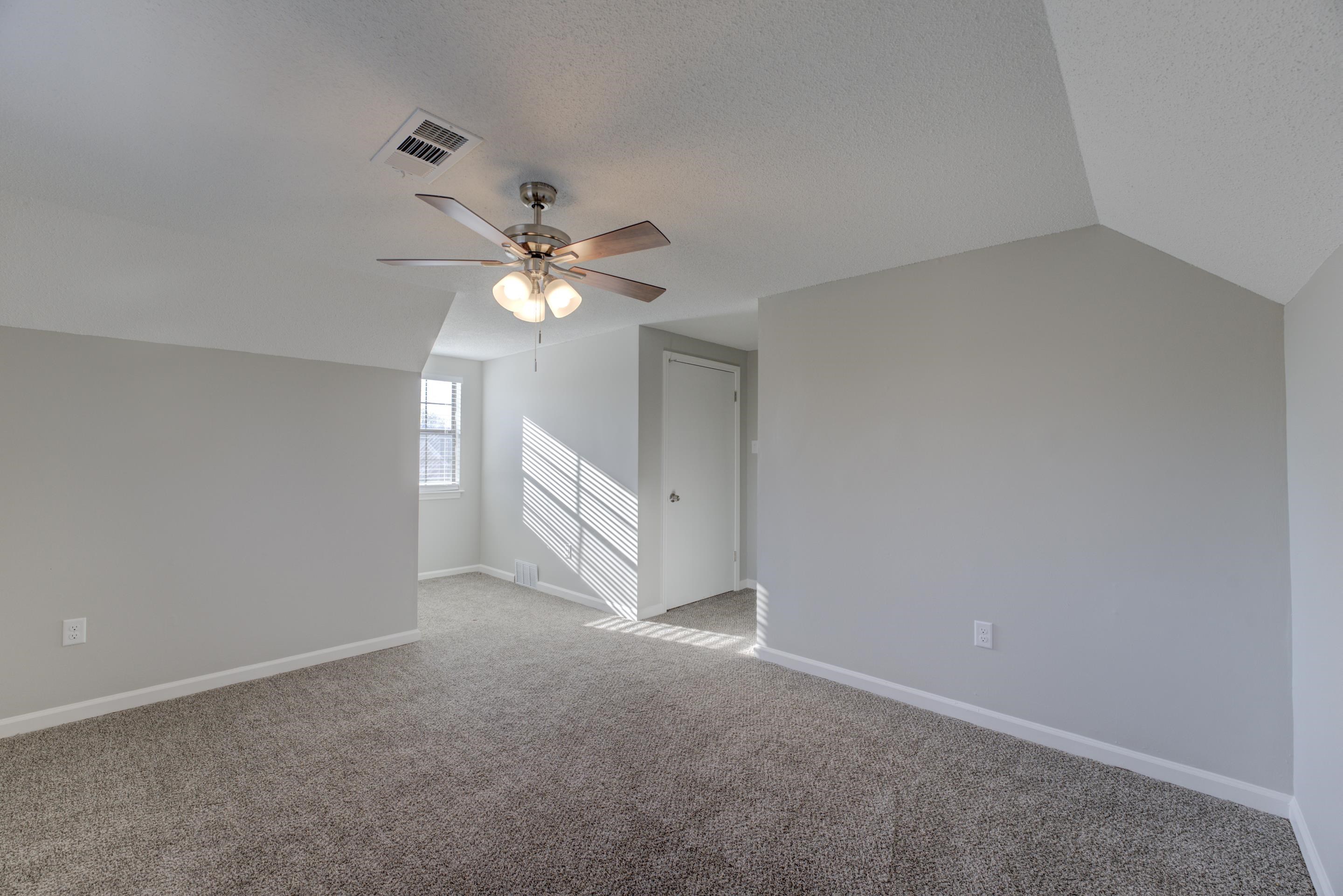 3808 Haynes Road Bartlett, TN 38133 - Photo 10 of 24 Additional living space with a textured ceiling, lofted ceiling, ceiling fan, and light colored carpet
