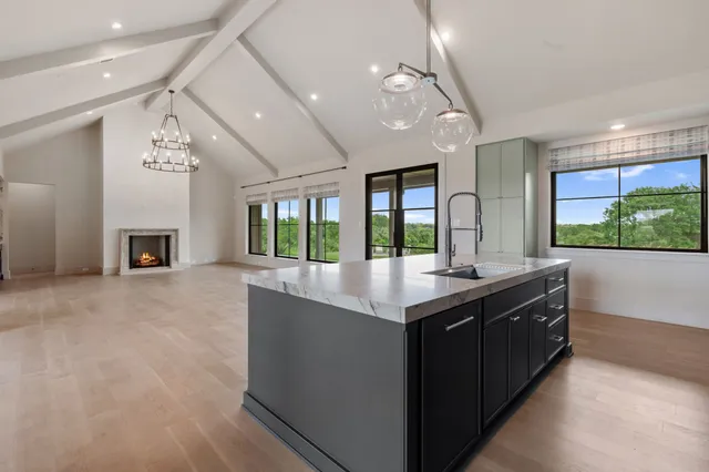 a kitchen with granite countertop a sink and a stove