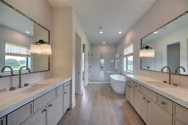 a spacious bathroom with a double vanity sink and a mirror