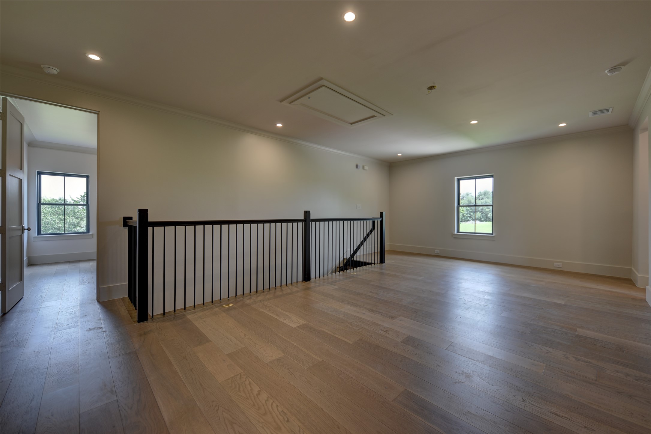 114 Turney Trace Round Top, TX 78954 - Photo 28 of 44 an empty room with wooden floor and windows