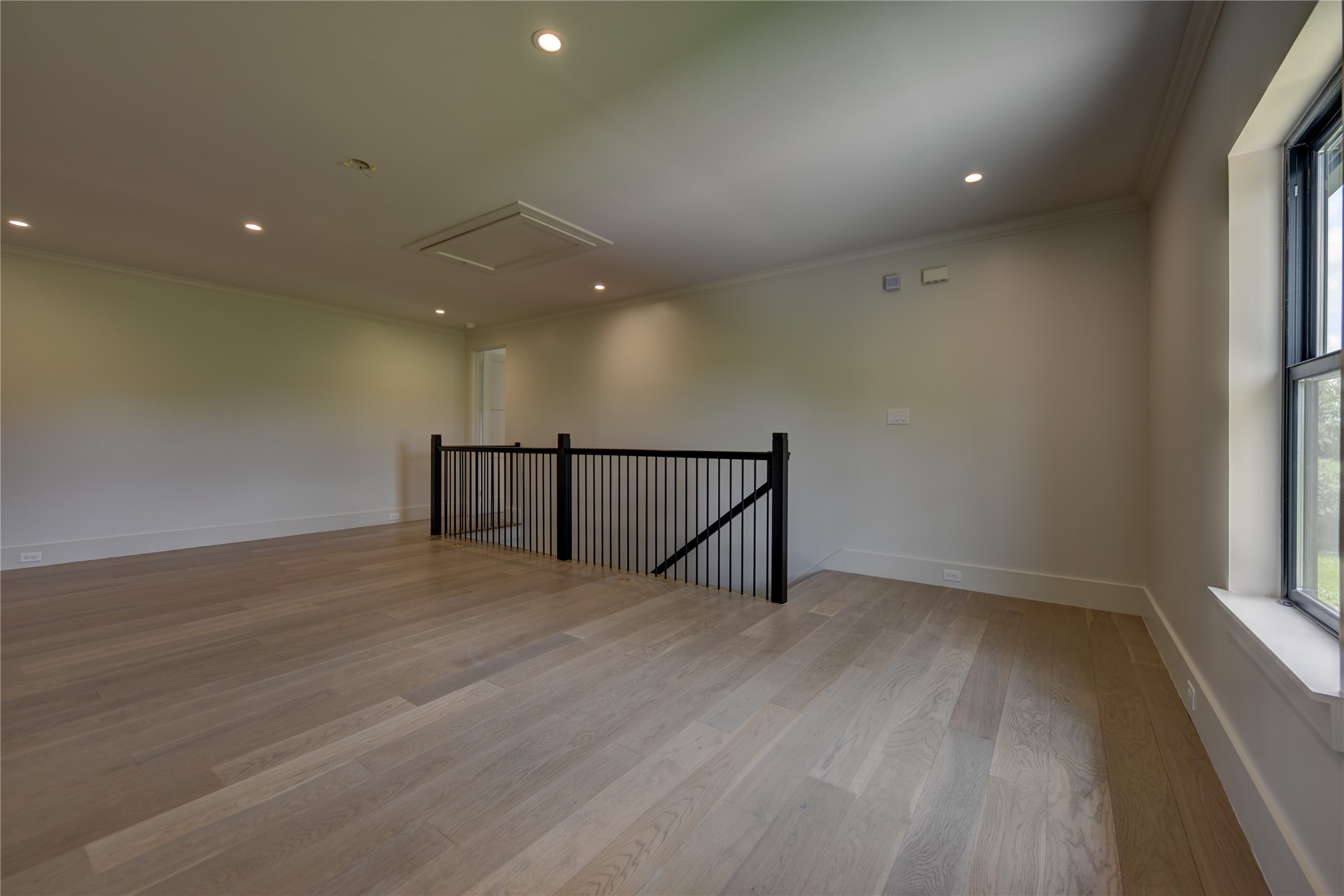 114 Turney Trace Round Top, TX 78954 - Photo 29 of 44 an empty room with wooden floor and windows