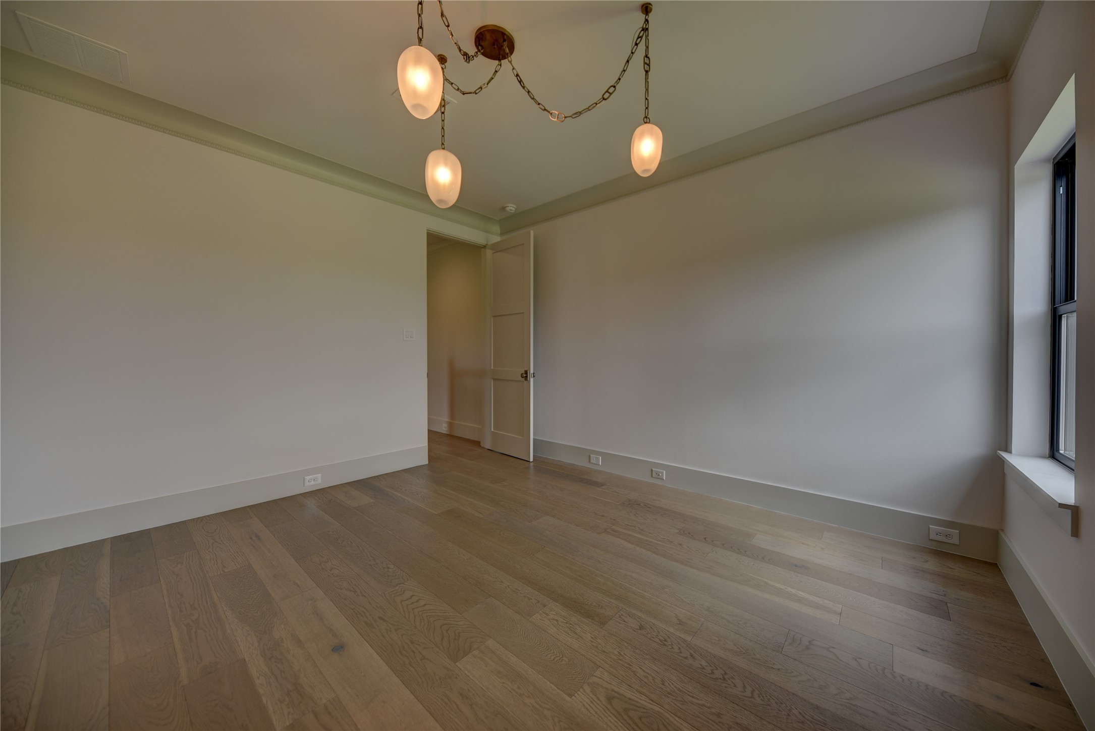 114 Turney Trace Round Top, TX 78954 - Photo 30 of 44 a view of an empty room with wooden floor and fan