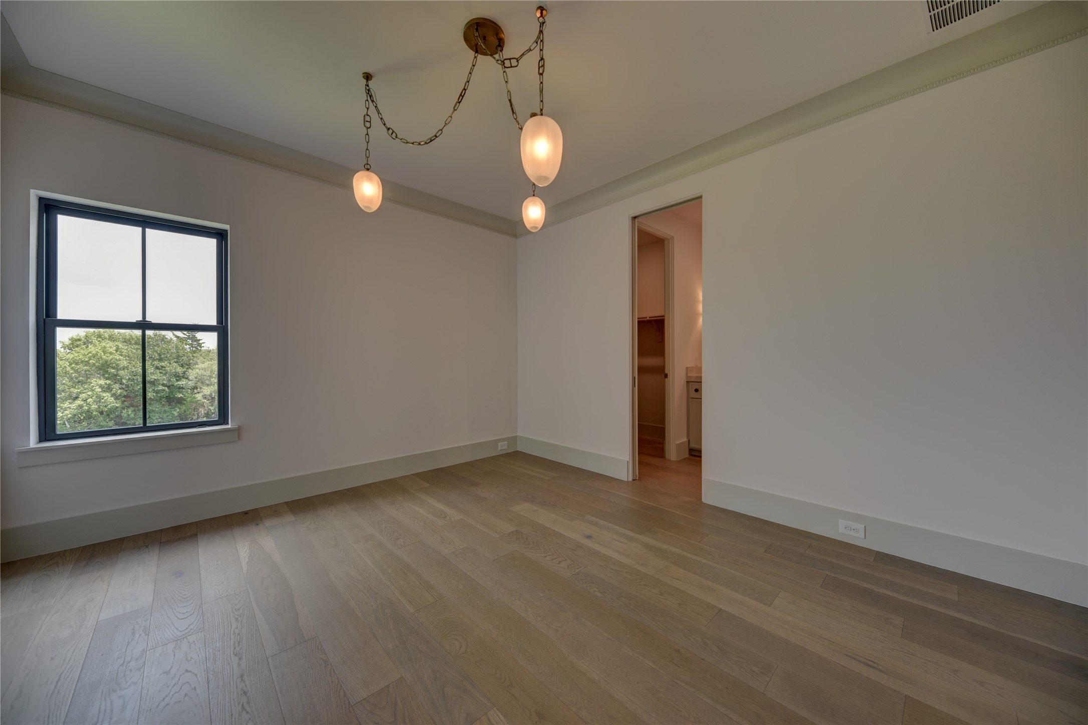 114 Turney Trace Round Top, TX 78954 - Photo 31 of 44 an empty room with wooden floor and windows