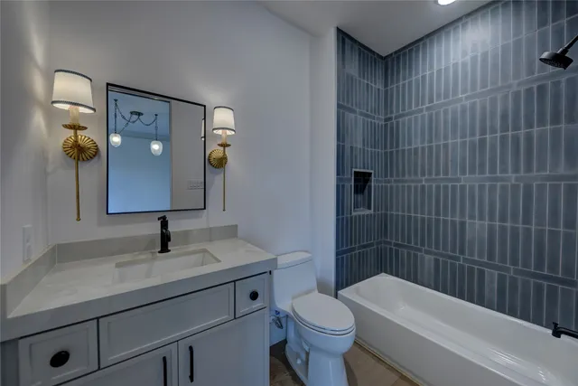 a bathroom with a toilet a sink a shower and mirror