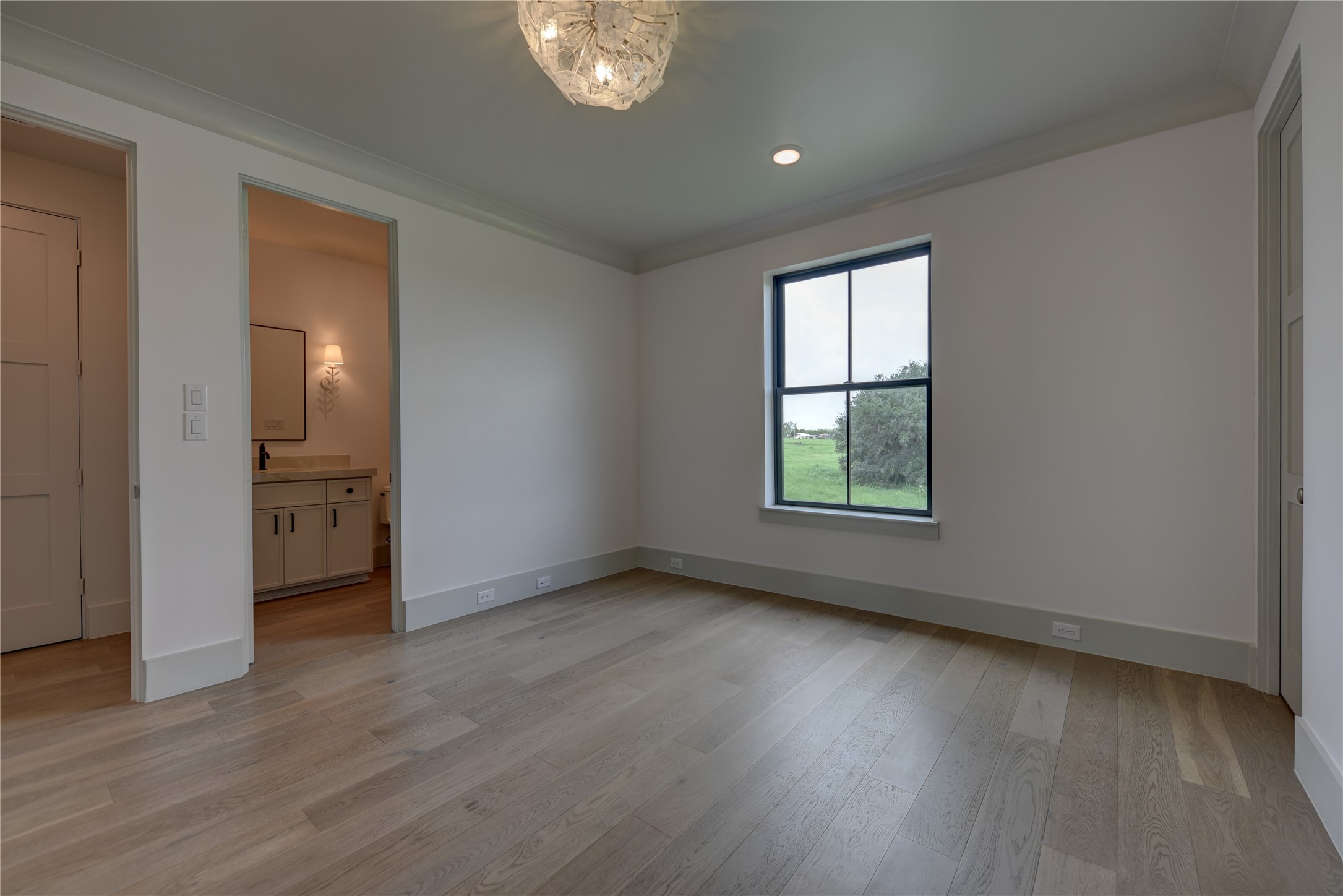 114 Turney Trace Round Top, TX 78954 - Photo 33 of 44 an empty room with wooden floor and windows