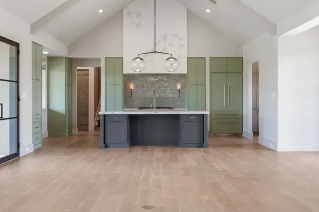 an empty room with a bathroom and mirror