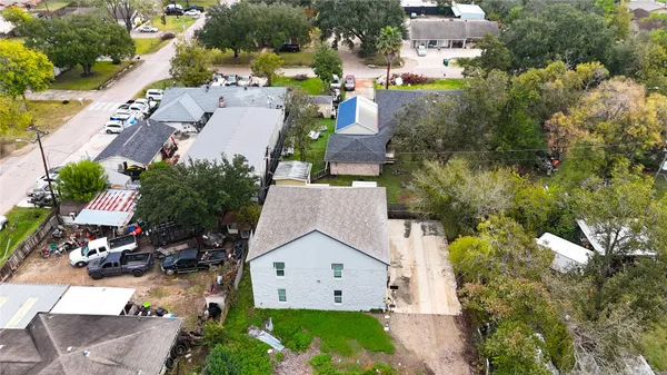 an aerial view of a house with a yard
