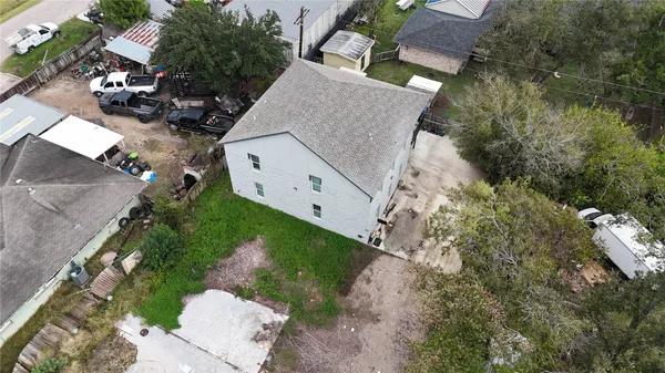 an aerial view of a house with a yard