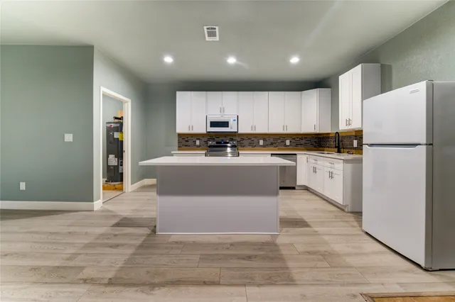 a kitchen with stainless steel appliances granite countertop a stove and a sink