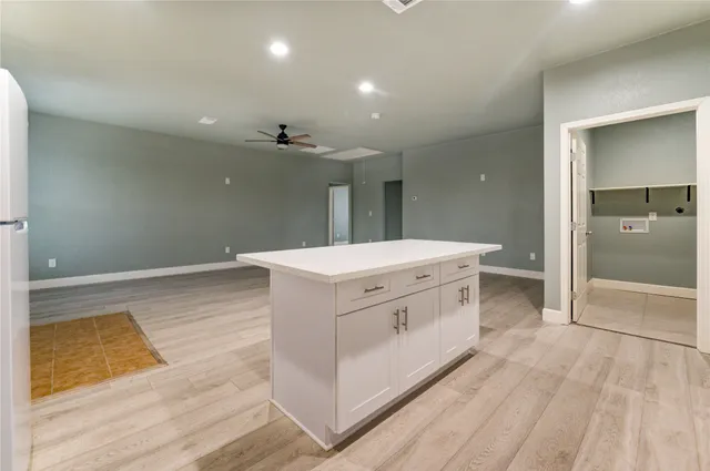 a kitchen with cabinets a sink and white stainless steel appliances
