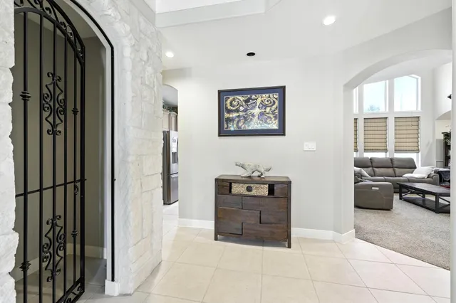 a view of a hallway with workspace and a window
