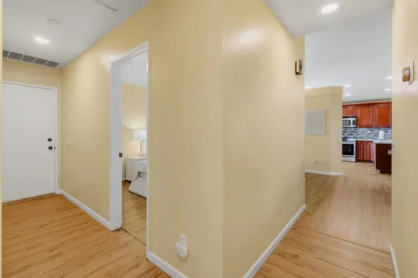 a view of a hallway with wooden floor