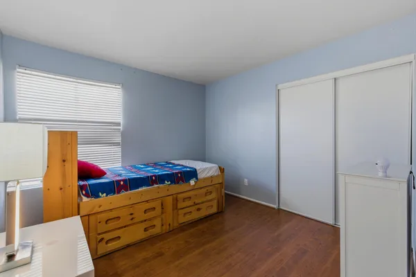 a room with window and dresser