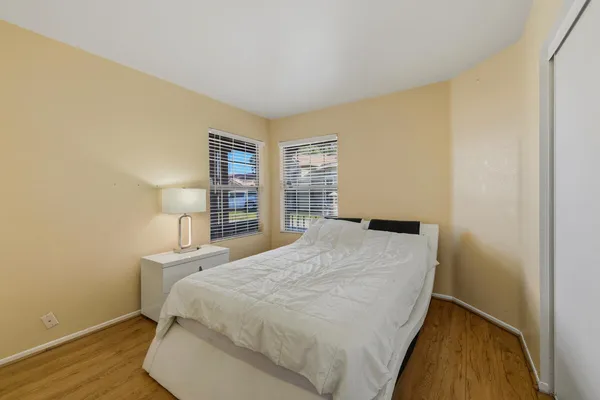 a bedroom with a bed and a night stand