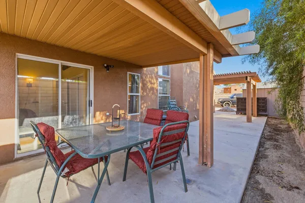 a dining room with furniture and wooden floor