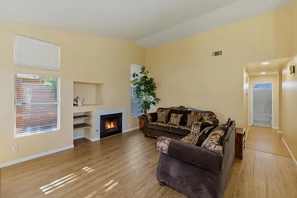 a living room with furniture mirror and a fireplace