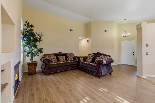 a living room with furniture and wooden floor