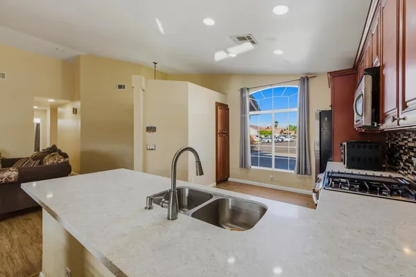 a kitchen with stainless steel appliances a sink and a large window