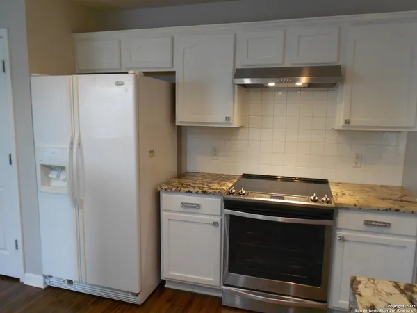 a kitchen with a stove and a refrigerator