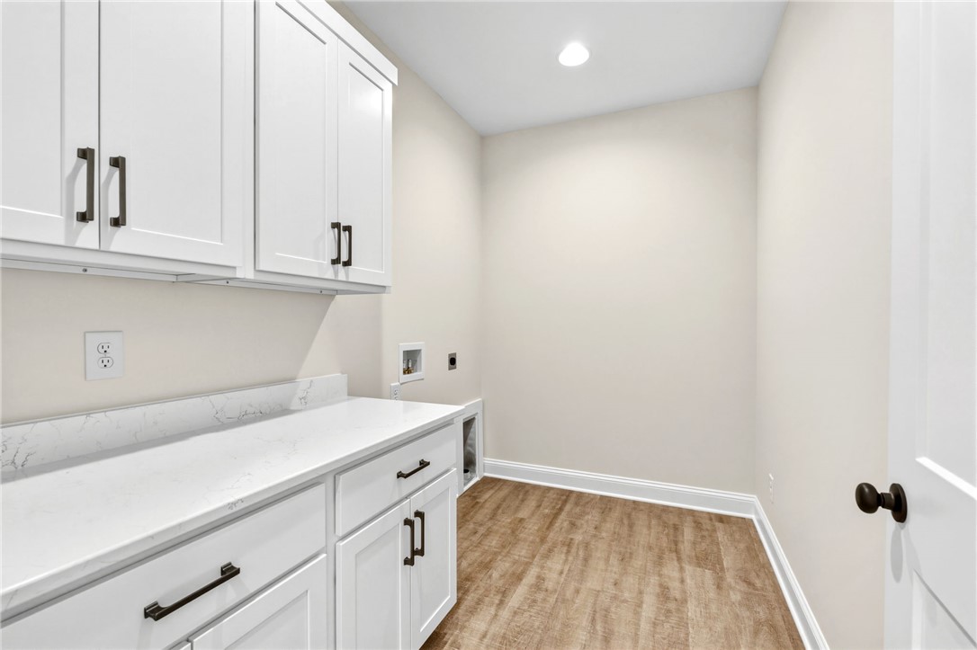 1735 Maw Bridge Road Central, SC 29630 - Photo 17 of 38 This functional laundry area features ample cabinetry and practical counter space for everyday tasks.