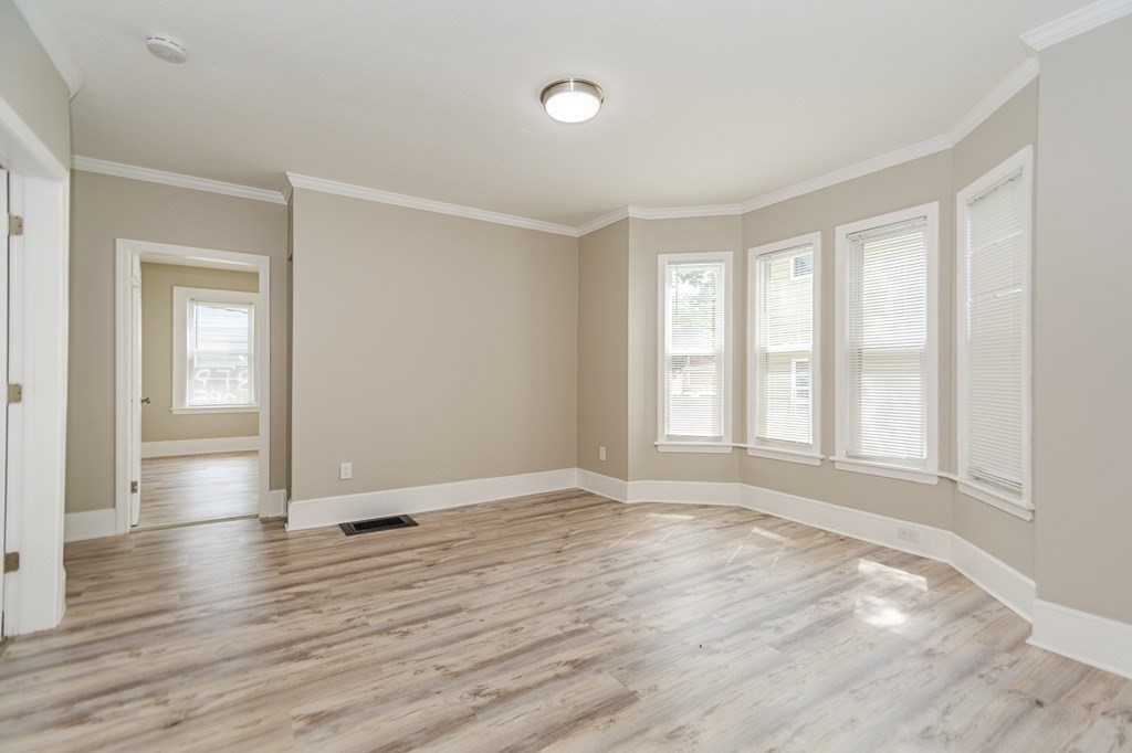 48 Washington Street Lawrence, MA 01841 - Photo 13 of 38 an empty room with wooden floor and windows