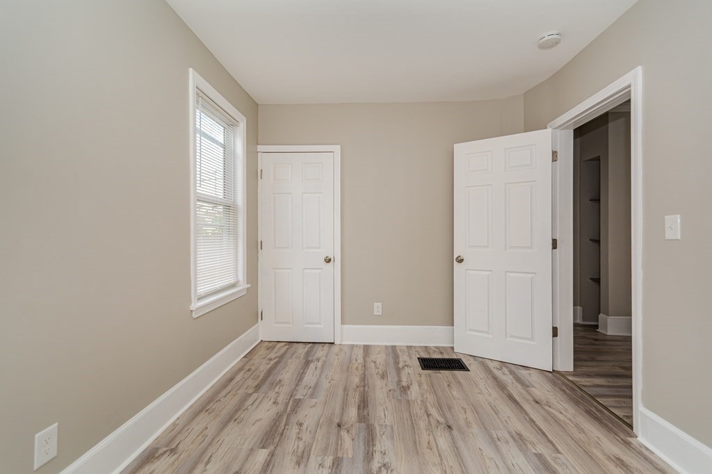 48 Washington Street Lawrence, MA 01841 - Photo 17 of 38 an empty room with wooden floor and windows
