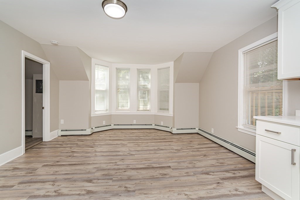 48 Washington Street Lawrence, MA 01841 - Photo 26 of 38 a view of an empty room with a window and wooden floor