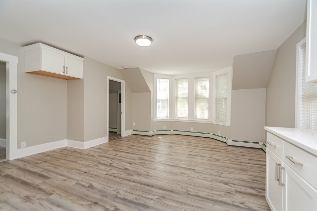 48 Washington Street Lawrence, MA 01841 - Photo 30 of 38 a view of an empty room with window and wooden floor