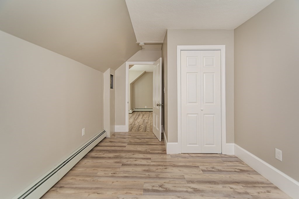 48 Washington Street Lawrence, MA 01841 - Photo 32 of 38 a view of a hallway with wooden floor