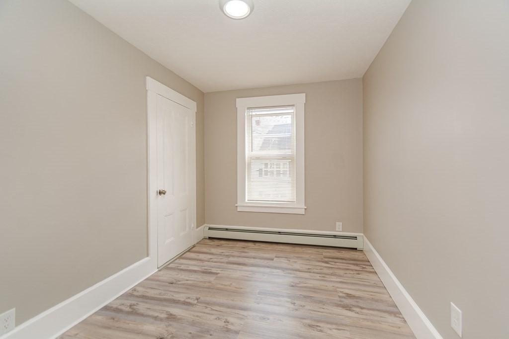 48 Washington Street Lawrence, MA 01841 - Photo 34 of 38 wooden floor in an empty room with a window