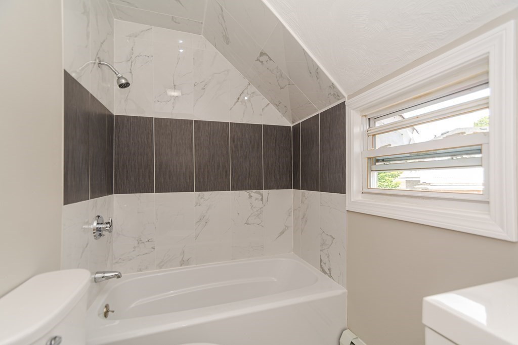 48 Washington Street Lawrence, MA 01841 - Photo 36 of 38 a bathroom with a bathtub and a shower