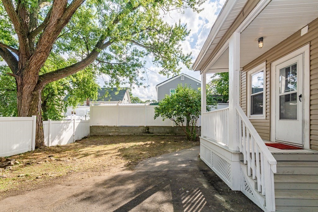 48 Washington Street Lawrence, MA 01841 - Photo 4 of 38 a view of a white house with a yard and balcony