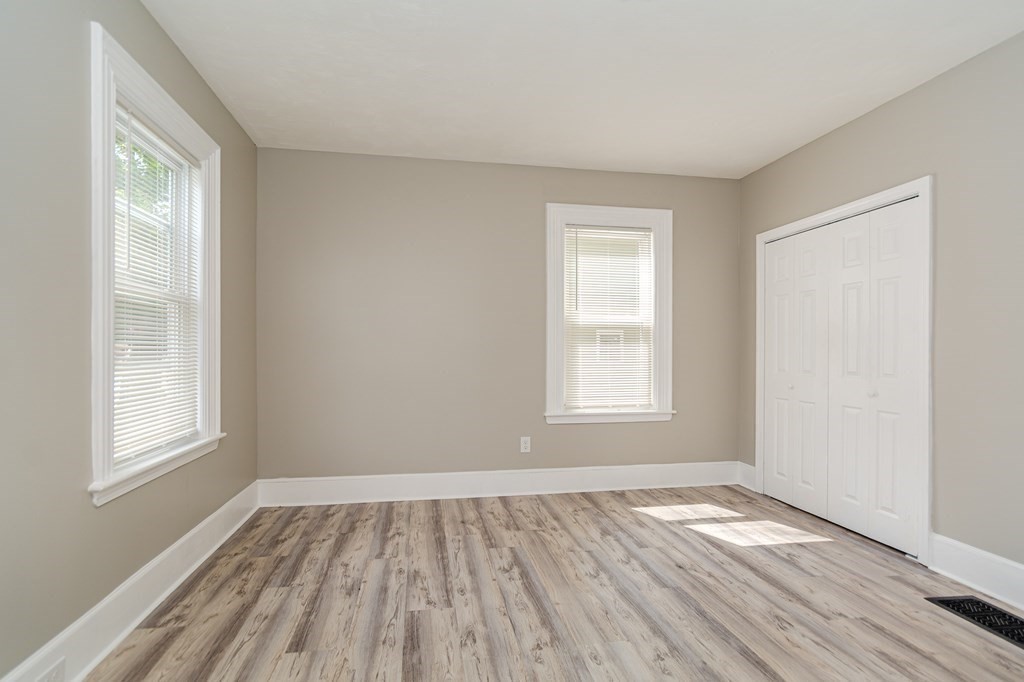 48 Washington Street Lawrence, MA 01841 - Photo 7 of 38 a view of empty room with wooden floor and fan