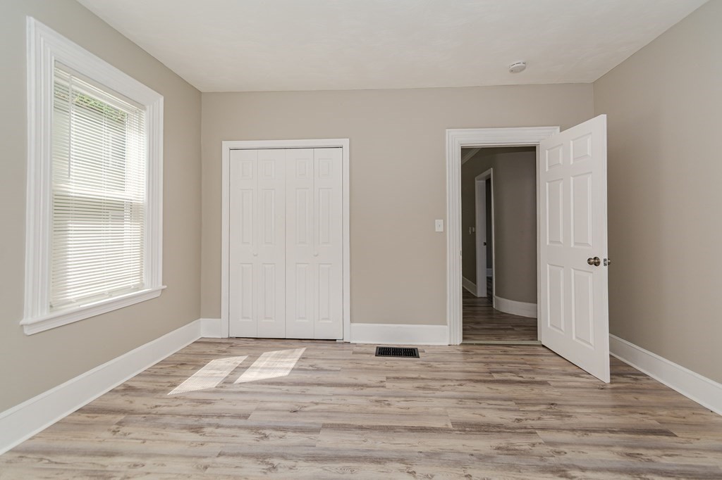 48 Washington Street Lawrence, MA 01841 - Photo 8 of 38 a view of an empty room with wooden floor and window