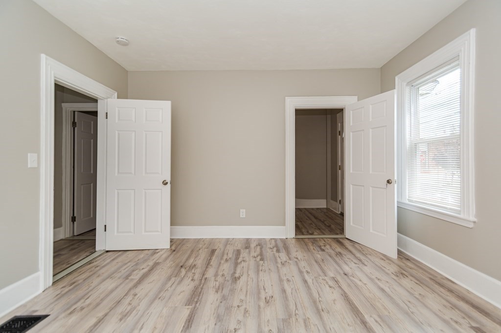 48 Washington Street Lawrence, MA 01841 - Photo 9 of 38 an empty room with wooden floor & windows
